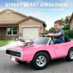 Front angle of a boy driving the pink First Ride On Dodge Charger RT with synchronized engine mist